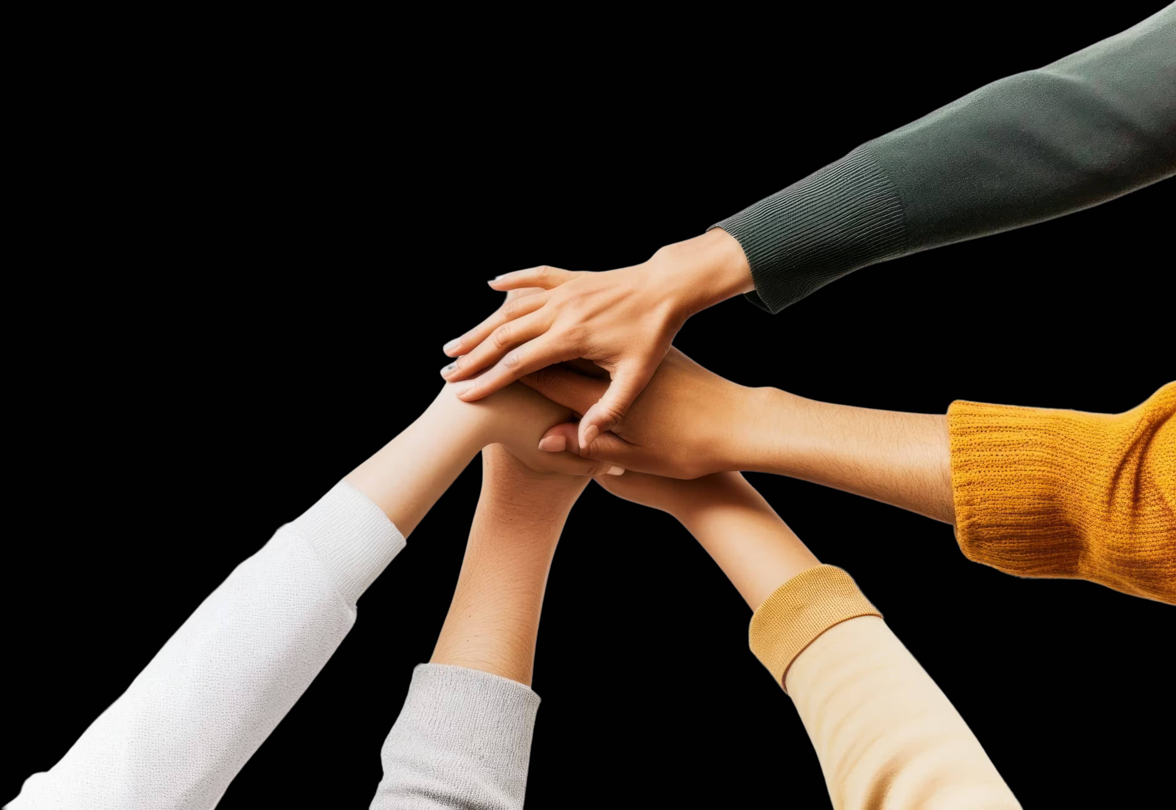 Multiple hands joined together in teamwork gesture