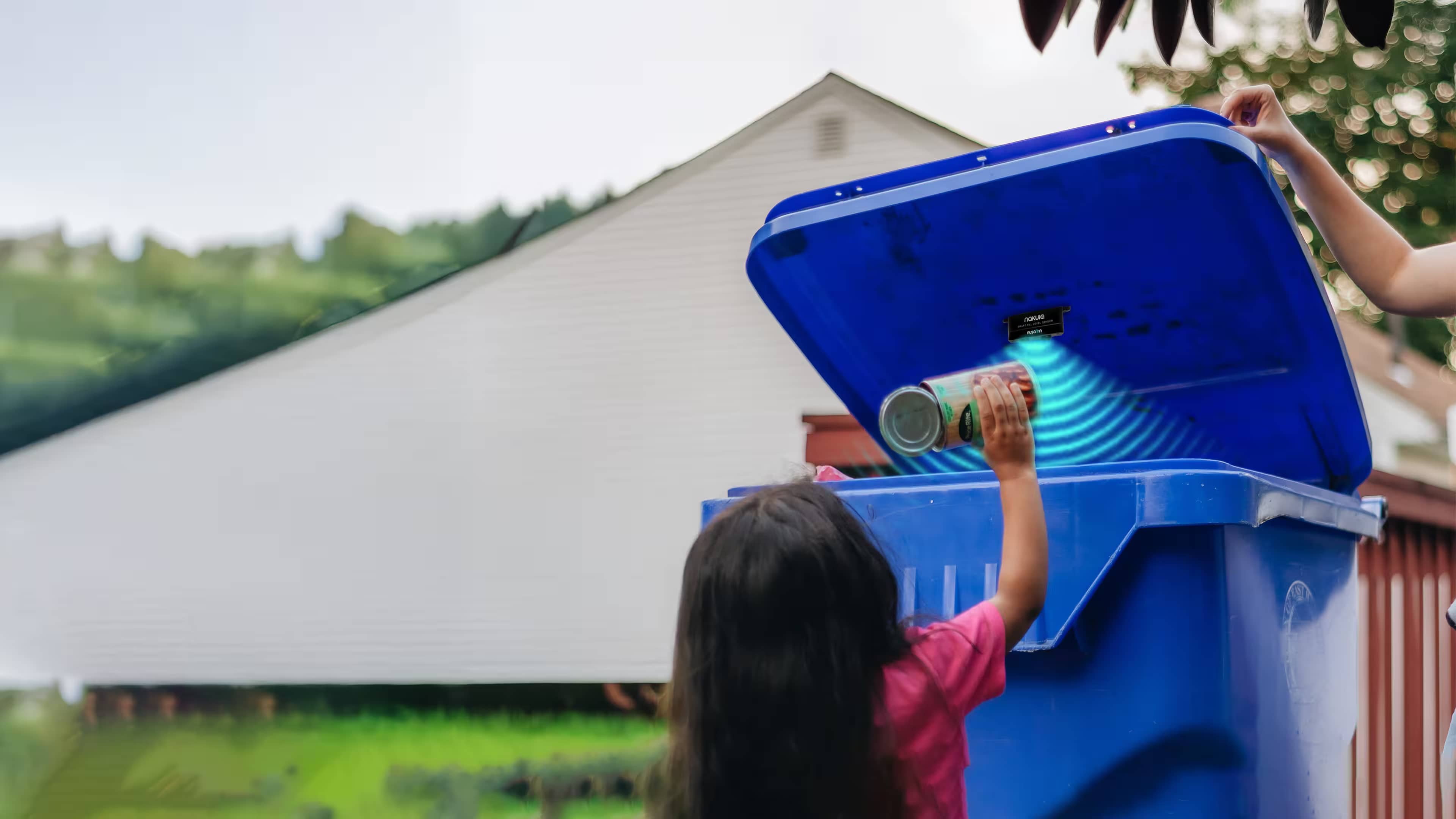 Child disposing waste in smart bin equipped with Nakula sensor